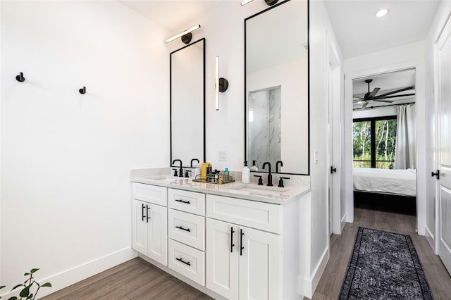 bathroom with ceiling fan, vanity, and hardwood / wood-style flooring