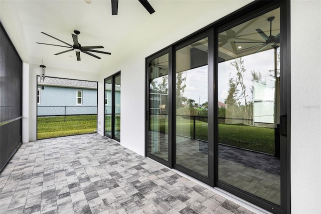 unfurnished sunroom featuring ceiling fan