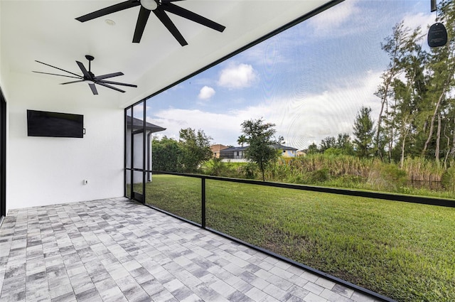 unfurnished sunroom with ceiling fan