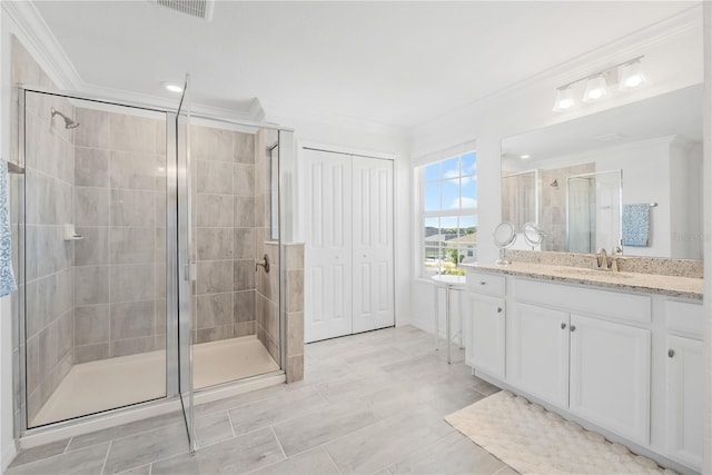 bathroom featuring vanity, walk in shower, and crown molding