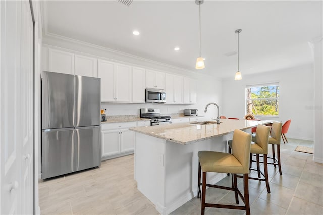 kitchen featuring sink, an island with sink, decorative light fixtures, white cabinetry, and stainless steel appliances