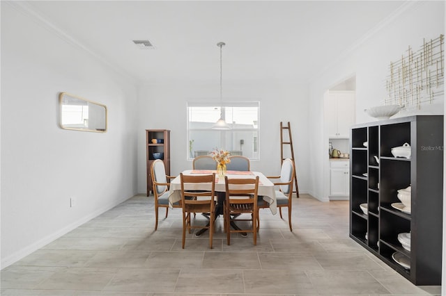 dining room featuring crown molding