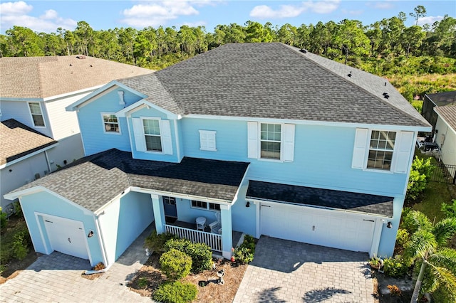 view of front of home featuring covered porch and a garage