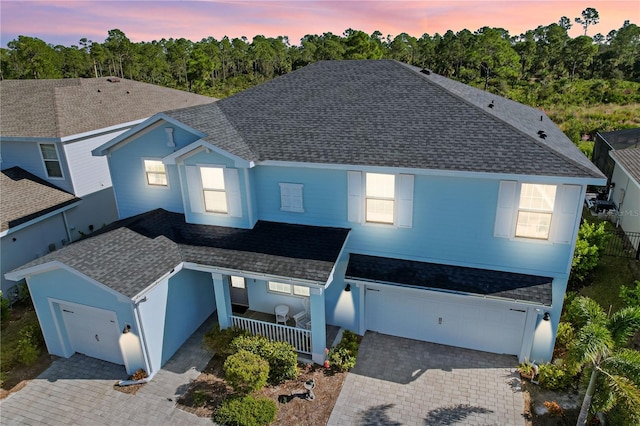 exterior space featuring covered porch and a garage