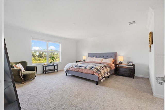 bedroom with light colored carpet and crown molding