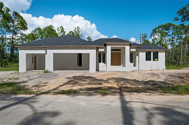 2502 Pinewood St, North Port, FL 34288 - prairie-style home featuring stucco siding and driveway