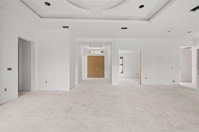 empty room featuring a raised ceiling