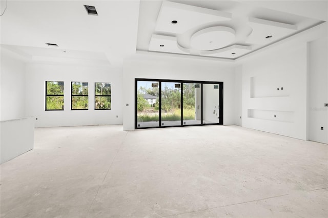 unfurnished living room with a tray ceiling