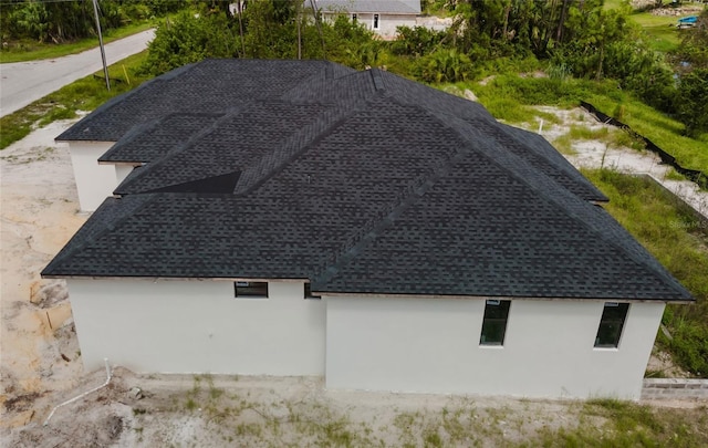 2502 Pinewood St, North Port, FL 34288 - exterior view of roof with shingles and stucco siding
