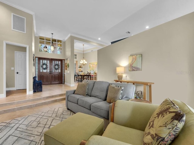 living room with an inviting chandelier, a towering ceiling, and light tile patterned floors