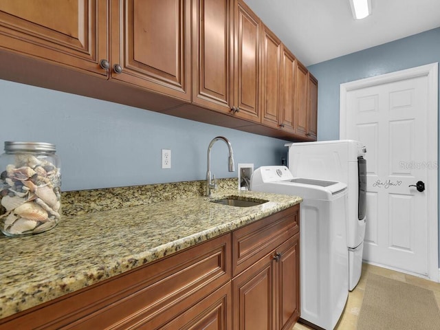 laundry area with cabinets, sink, and washer and dryer