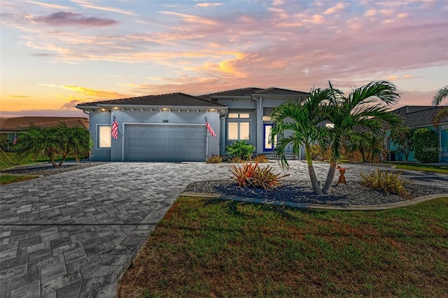 view of front of house with a yard and a garage