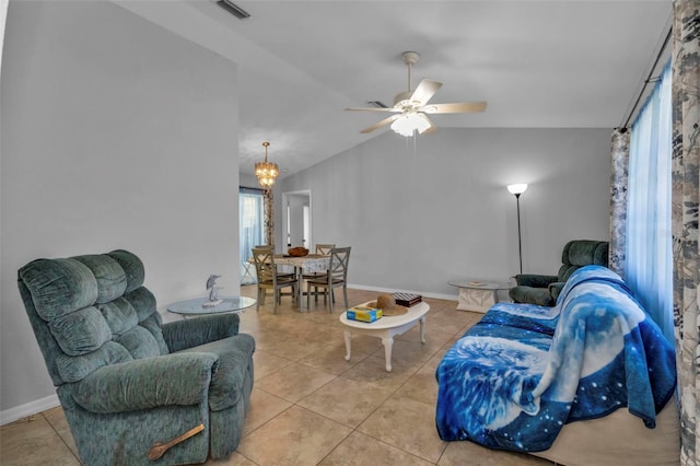 tiled living room featuring ceiling fan with notable chandelier and lofted ceiling