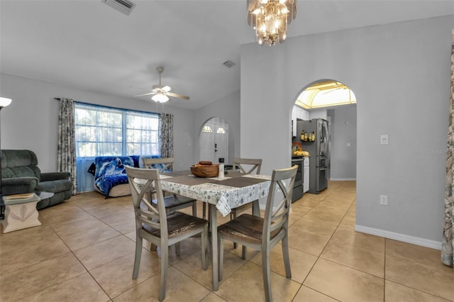 dining area with ceiling fan with notable chandelier and light tile patterned floors