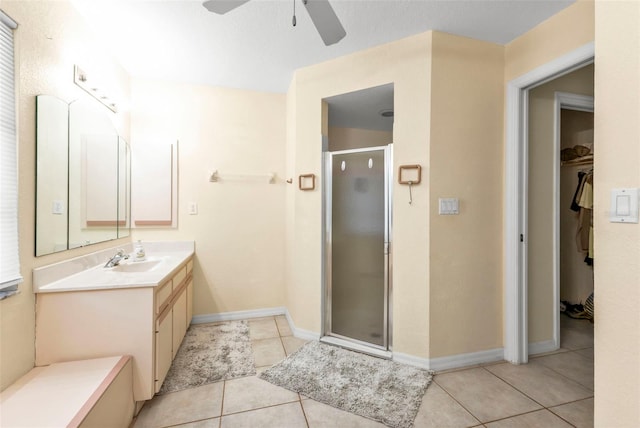 bathroom with ceiling fan, vanity, an enclosed shower, and tile patterned floors