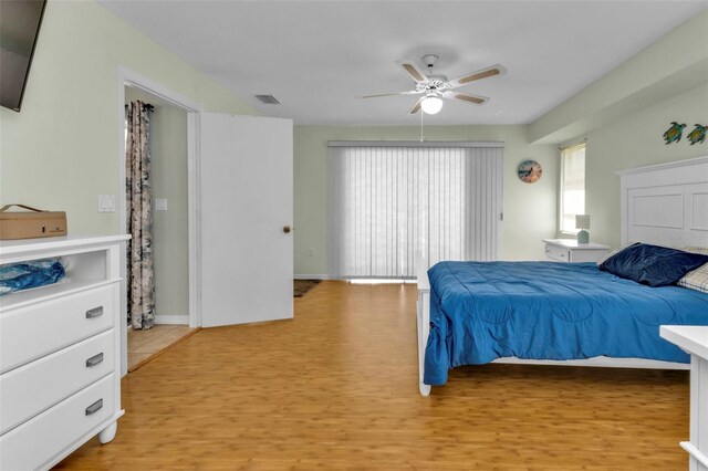 bedroom with light hardwood / wood-style floors and ceiling fan