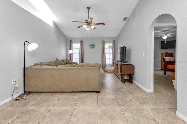 tiled living room with lofted ceiling and ceiling fan