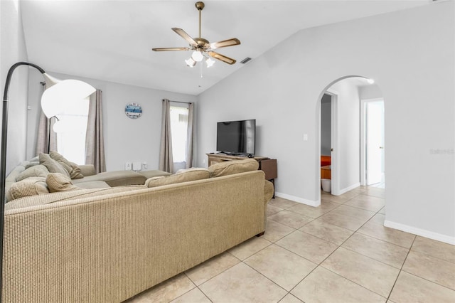 tiled living room featuring ceiling fan and high vaulted ceiling