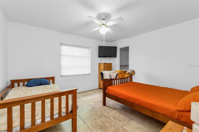 tiled bedroom featuring ceiling fan