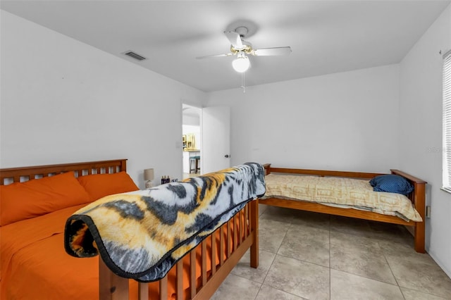 bedroom featuring ceiling fan and tile patterned floors