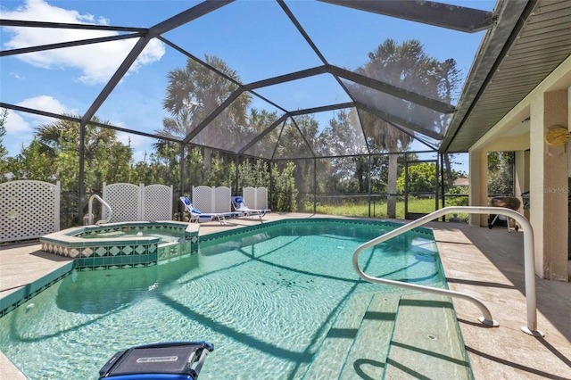 view of pool featuring a patio, glass enclosure, and an in ground hot tub