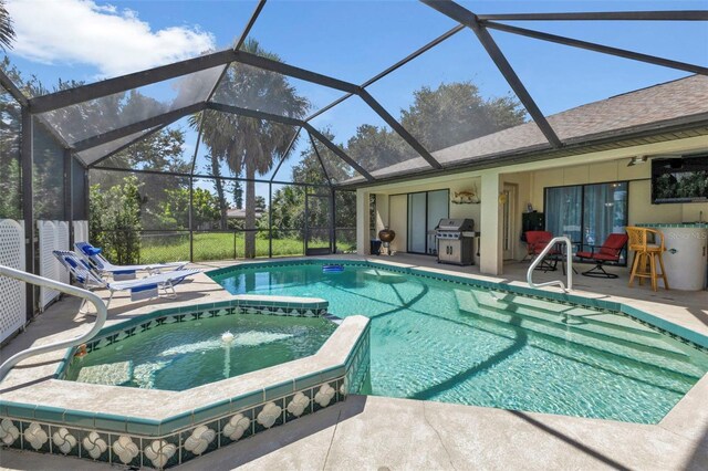 view of pool with a patio, glass enclosure, an in ground hot tub, and a grill