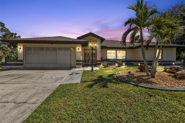 view of front of house with a lawn and a garage