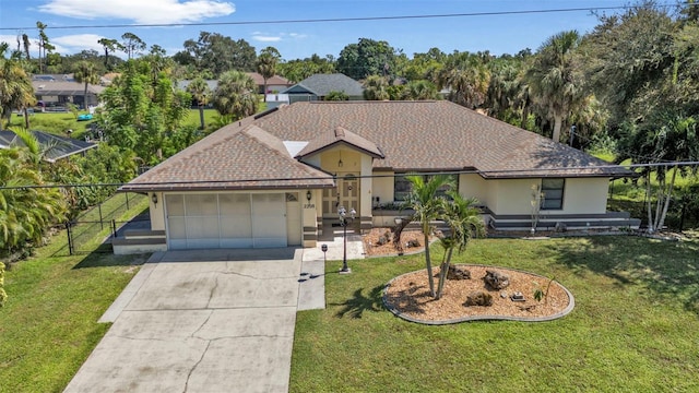 single story home featuring a garage and a front lawn