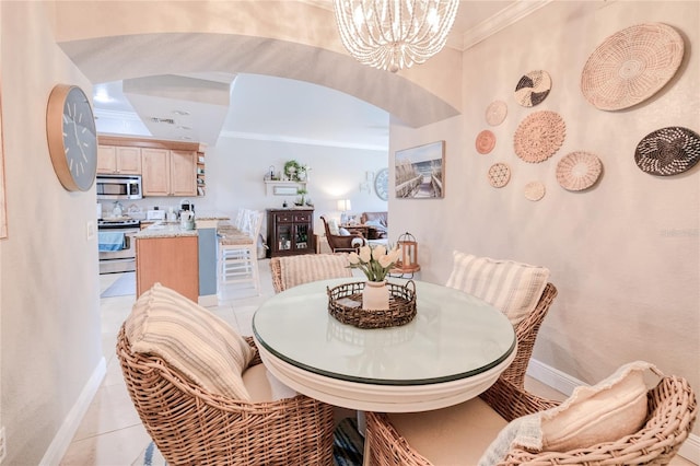 dining area featuring crown molding, a notable chandelier, and light tile patterned floors