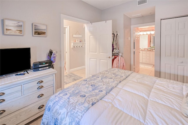 carpeted bedroom with a closet and ensuite bathroom