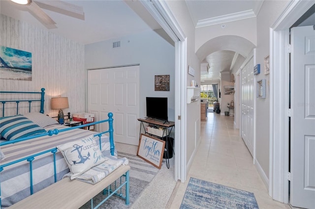 hallway featuring light tile patterned floors and ornamental molding