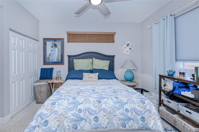 bedroom with ceiling fan and a closet