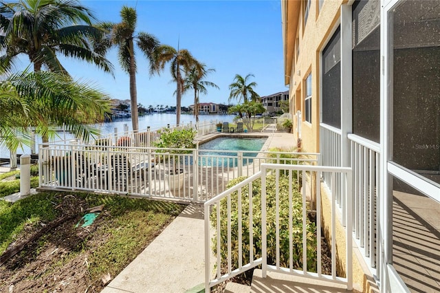 view of swimming pool with a water view