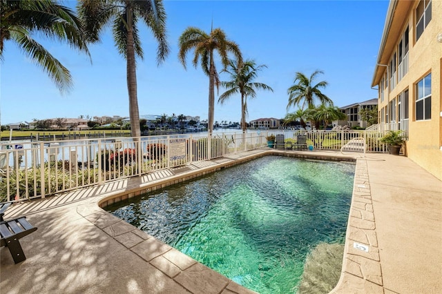 view of pool featuring a water view and a patio