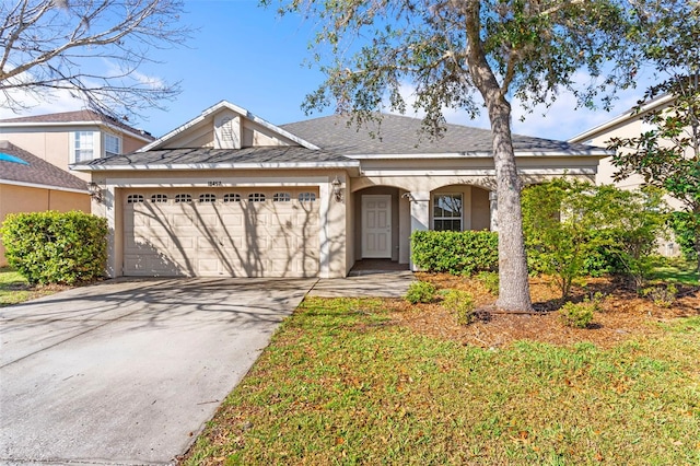 view of front facade featuring concrete driveway, an attached garage, and stucco siding