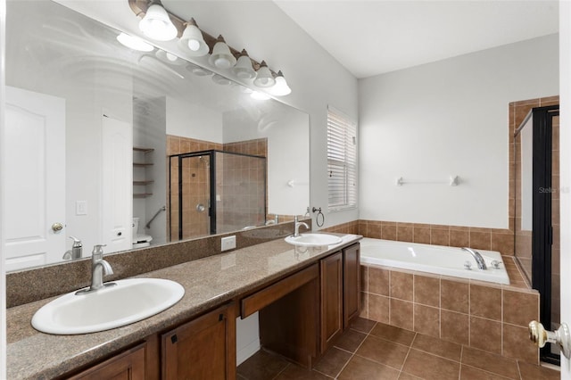 full bath with a stall shower, a sink, a bath, and tile patterned floors