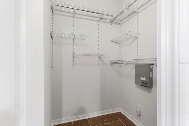 spacious closet featuring dark tile patterned floors