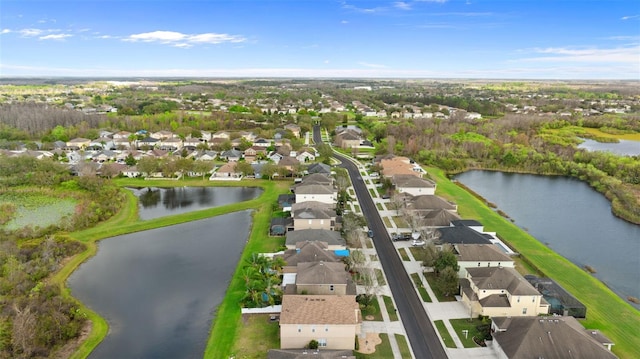 birds eye view of property with a water view and a residential view