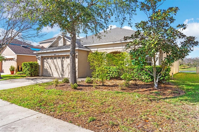 view of side of property with a garage, concrete driveway, and stucco siding