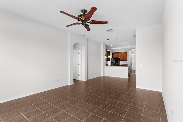 empty room featuring arched walkways, recessed lighting, visible vents, ceiling fan, and baseboards