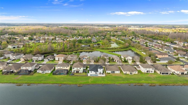 drone / aerial view with a water view and a residential view