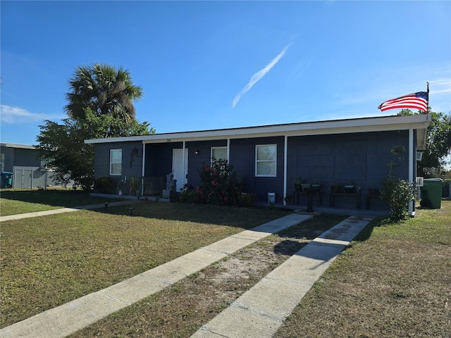 single story home featuring cooling unit and a front lawn