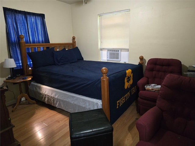 bedroom featuring hardwood / wood-style floors and cooling unit