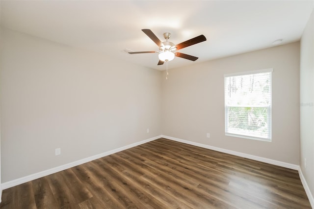 unfurnished room with ceiling fan and dark wood-type flooring