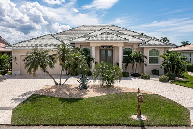 view of front of home with a front yard and a garage