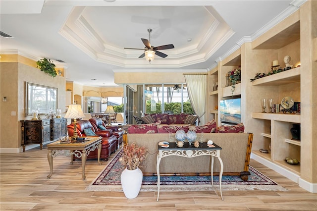 living room with crown molding, ceiling fan, light hardwood / wood-style floors, and plenty of natural light