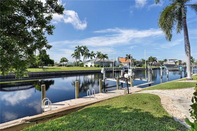 view of dock with a water view and a lawn