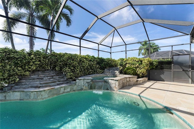 view of pool featuring a patio, a lanai, and an in ground hot tub