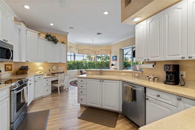 kitchen featuring appliances with stainless steel finishes, white cabinets, and light wood-type flooring