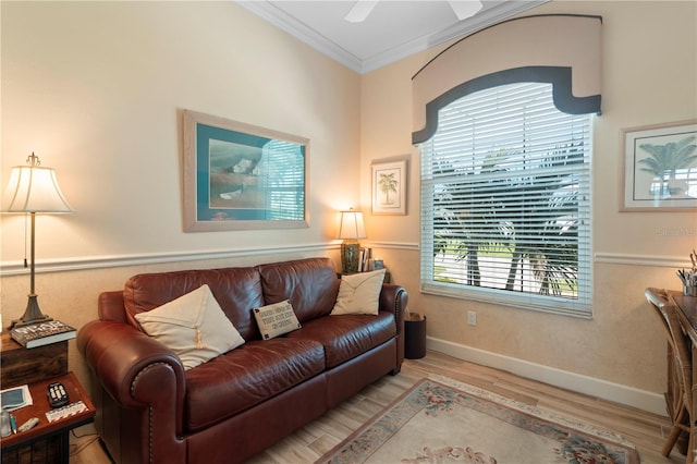 living room with crown molding, light hardwood / wood-style floors, and ceiling fan